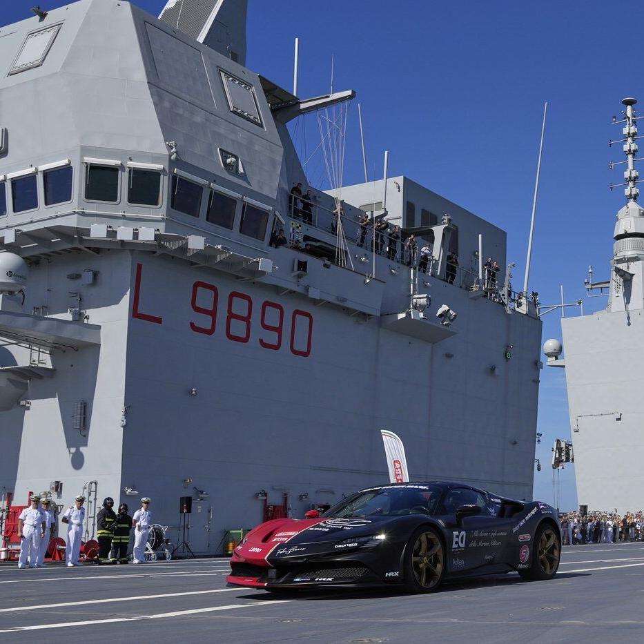 One man in an Italian supercar atop an aircraft carrier has a record in his sights